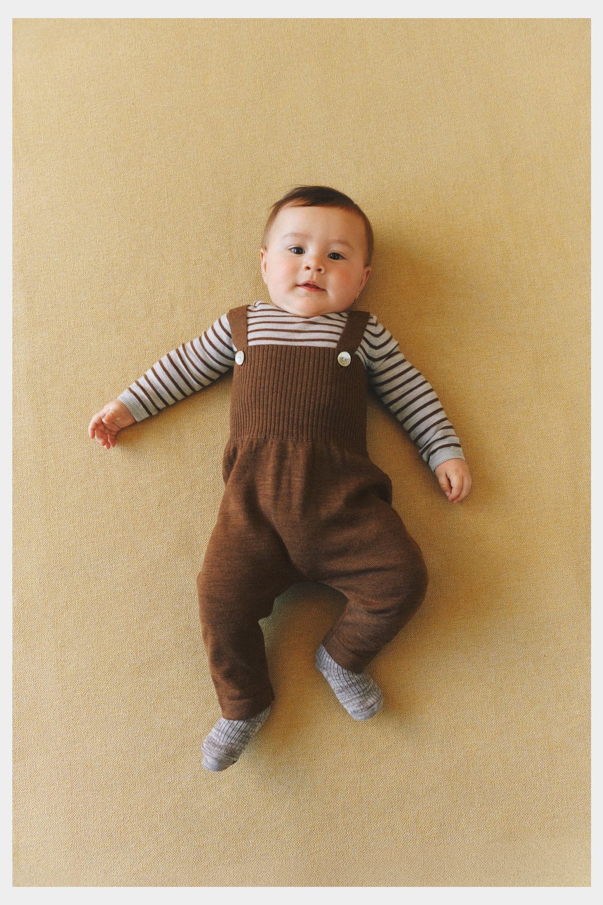 Baby wearing FUB Baby Body in light grey melange and hazel melange
